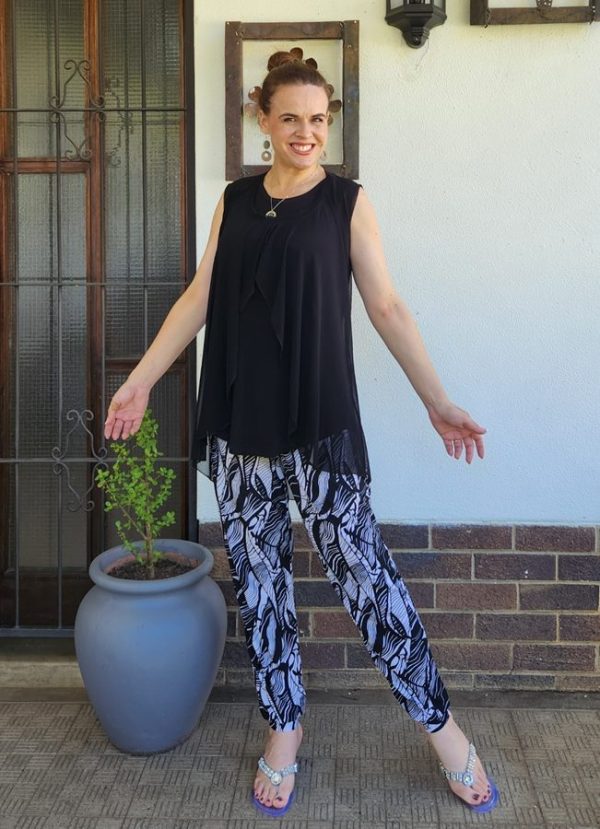 Hesti Front Open Top in Black Sleeveless Mesh, layered over the Sleeveless Marinda Round Hem Top, paired with Sulay Cuff Pants in Bon-Bon fabric. Custom-made by J&S Creations in South Africa, this outfit combines elegance and comfort for a stylish, polished look.