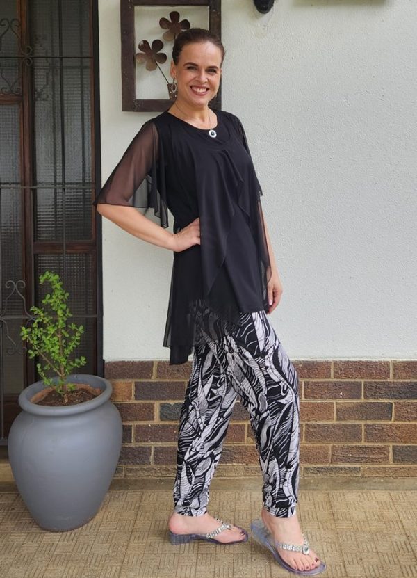 Hesti Front Open Top in Black Mesh with Flared Sleeves, layered over the Sleeveless Marinda Round Hem Top, paired with Sulay Cuff Pants in Bon-Bon fabric. Custom-made by J&S Creations in South Africa, this outfit combines elegance and comfort for a stylish, polished look.