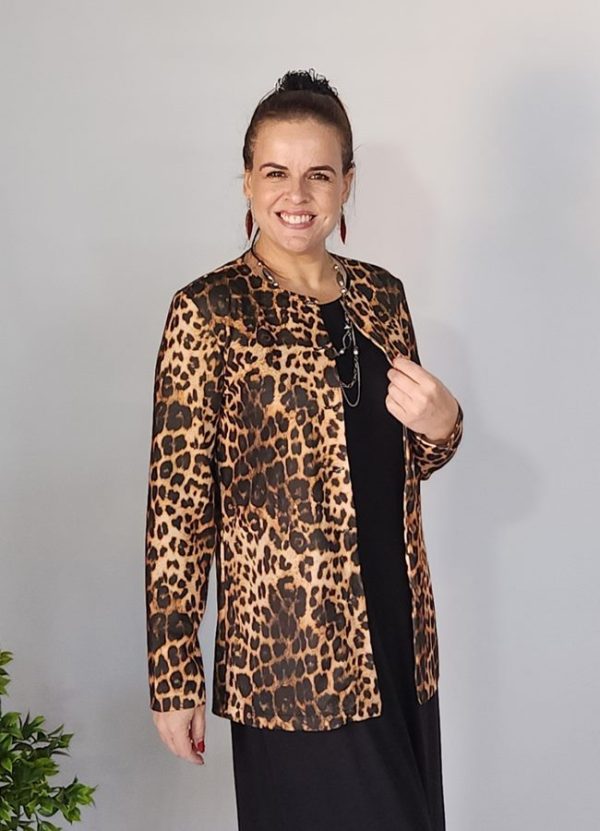 Woman wearing the Emily Button Detail Jacket in a stylish leopard print pattern