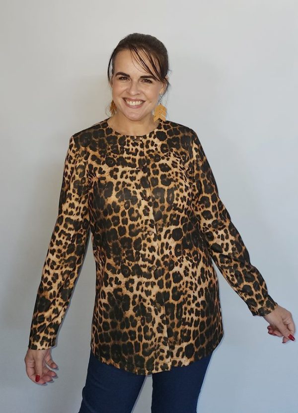 Woman wearing the Emily Button Detail Jacket in a stylish leopard print pattern