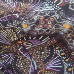 Viscose Spandex with a dark brown background and earthy mustard, burgundy, and purple print