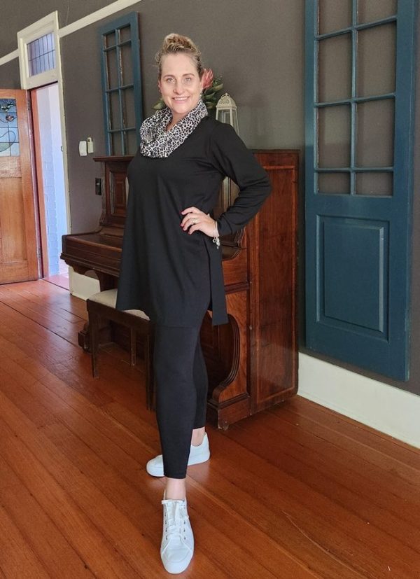 Stylish woman in the Lilly 3-Piece Set by J&S Creations, featuring a black Ponti Roma top with side slits, plain black DTY brush knit leggings, and a contrasting leopard print snood. Made in South Africa for everyday elegance and available in sizes Small to 6XL.