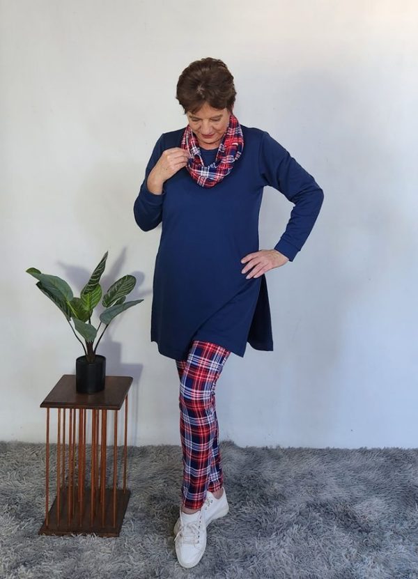 Elegant older woman modeling a custom-made Lilly 3-Piece Set by J&S Creations, featuring a navy Terry Knit top with side slits, red and navy checkered DTY brush knit leggings, and a matching snood scarf. Proudly made to fit real South African women, this comfortable and stylish winter outfit is available in sizes Small to 6XL.