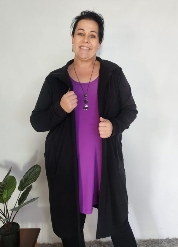 Woman wearing the Zelda Cosy Collar Pocket Cardigan in black cosy spandex knit, styled over a purple top – custom-made for winter in South Africa.