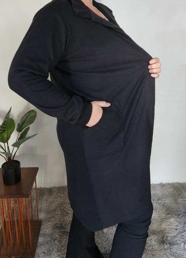 Side view of the Zelda Cosy Collar Pocket Cardigan in black cosy spandex knit, highlighting the practical front pocket and soft stretch fabric. Made to fit from Small to Plus Size.